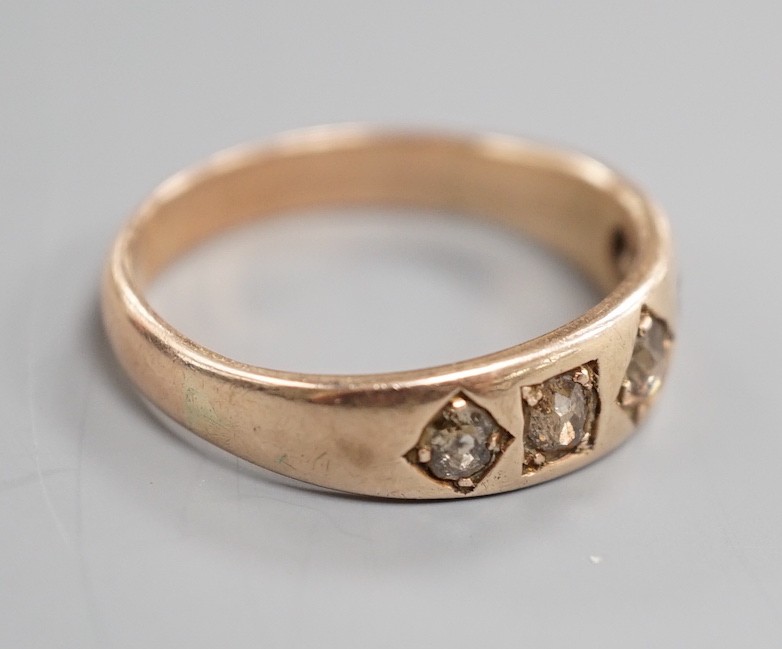 An early 20th century yellow metal and gypsy set graduated five stone diamond half hoop ring, size Q. gross weight 3.6 grams.